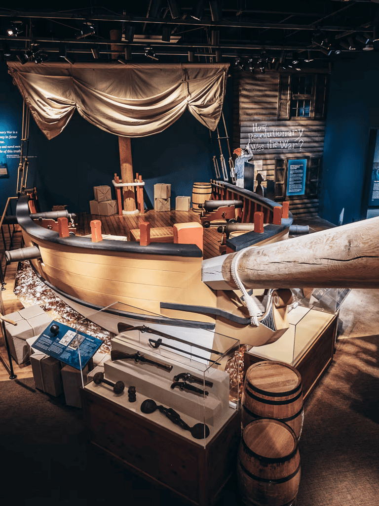 Pirate ship exhibit with cannons and historical artifacts at a maritime museum.
