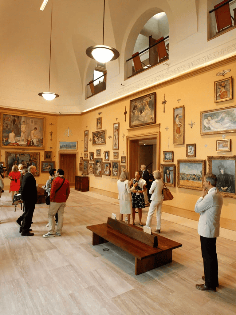 Beauty and cultural art gallery featuring classic oil paintings and visitors exploring the artwork.