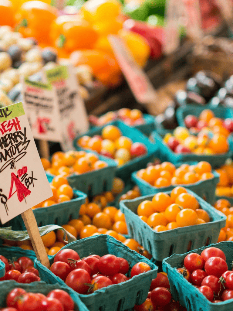 Fresh organic tomatoes at farmer's market, vibrant and healthy produce for sale.