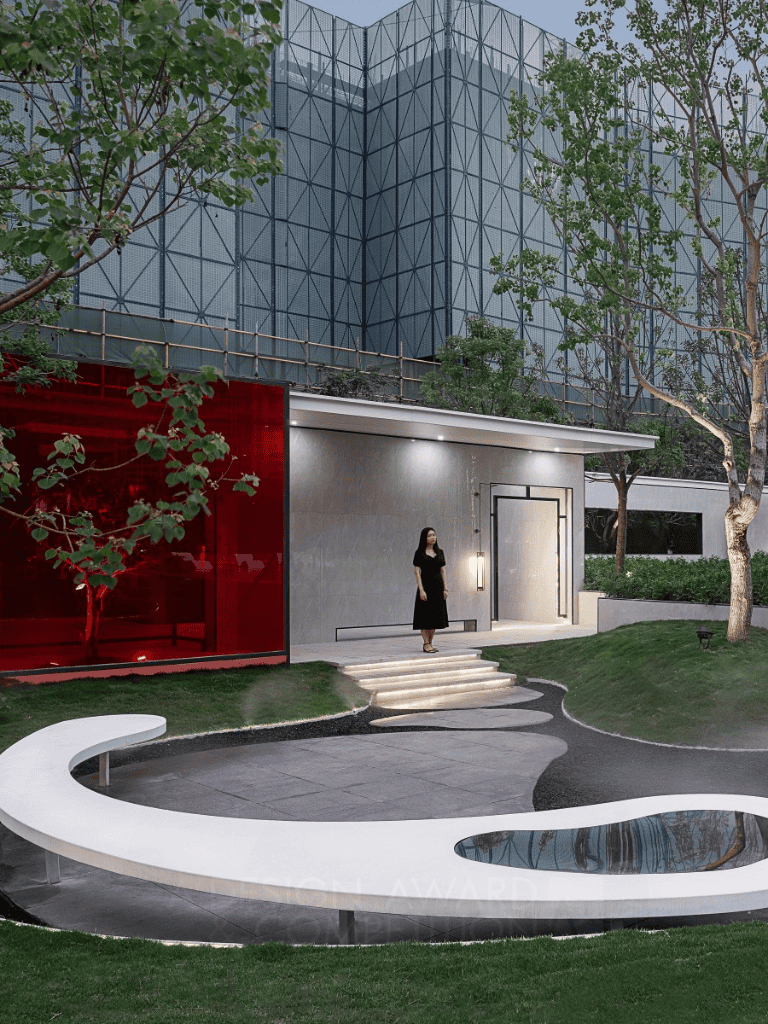 Modern corporate building with landscaped garden and unique water feature, perfect for business visits.