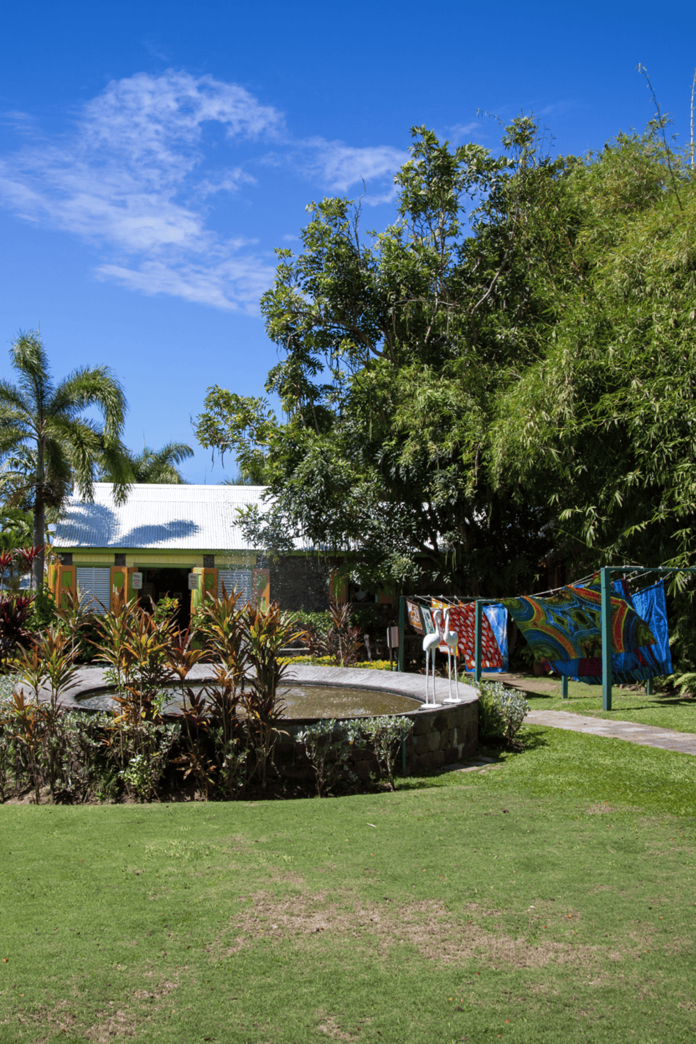 Colorful outdoor garden with lush trees and vibrant artwork, perfect for relaxation and leisure activities.