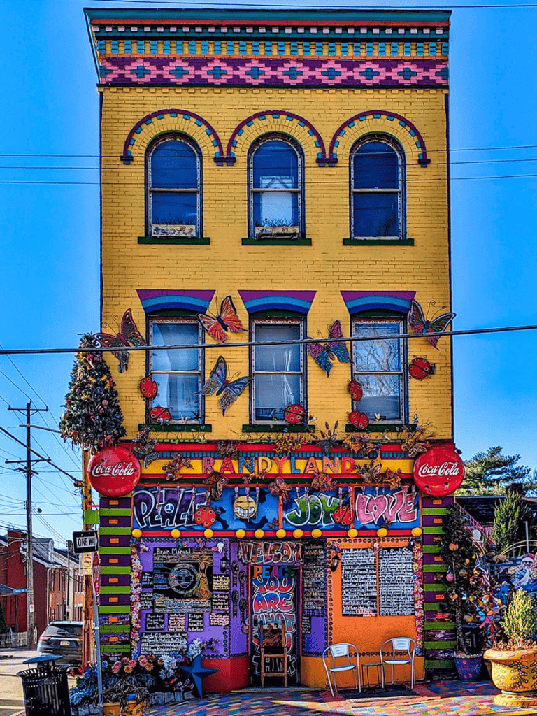 Colorful, vibrant building with butterfly and ladybug decorations, celebrating love and joy in a creative, artistic neighborhood scene.