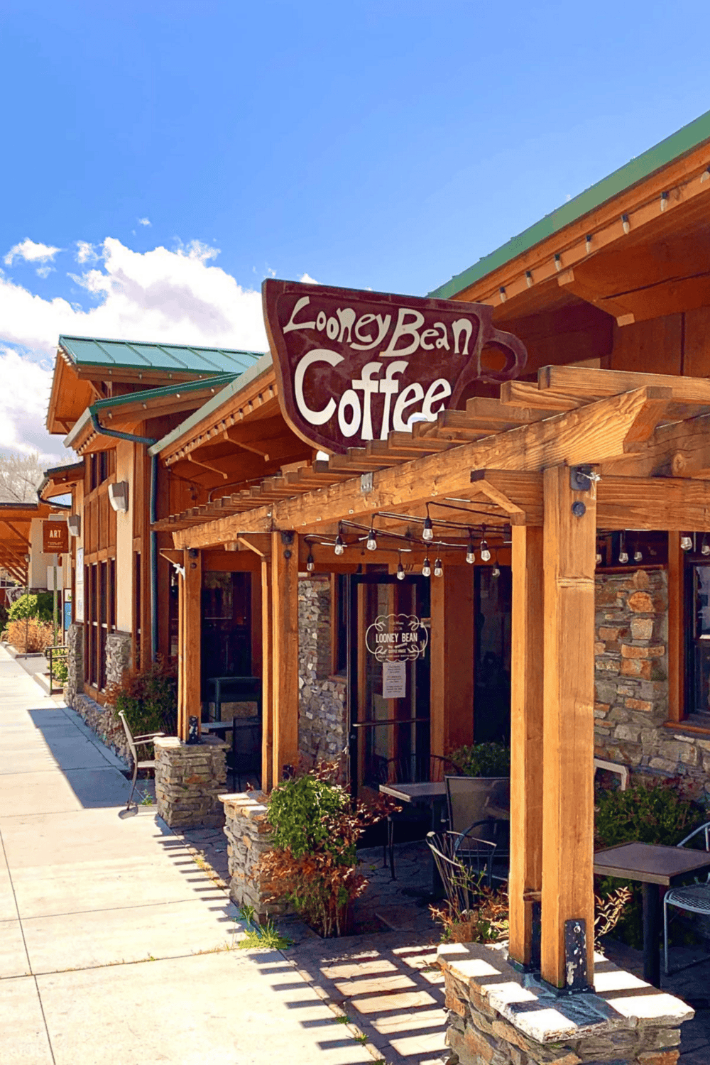 Cozy Looney Bean Coffee shop with rustic wooden exterior and outdoor seating, perfect for relax and refreshment.