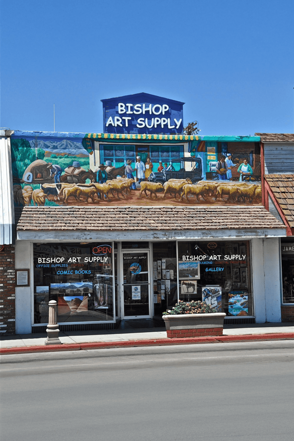 Vintage art supply store exterior with vibrant mural.
