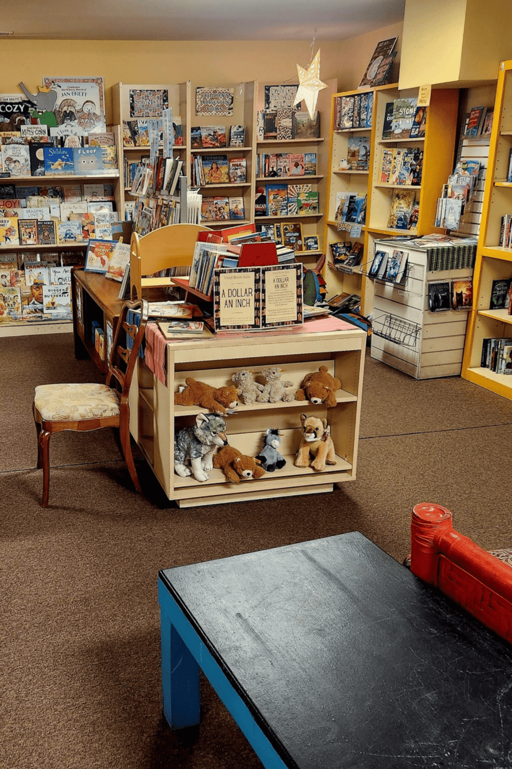 Delightful bookstore display with children's toys and books, perfect for family-friendly reading and browsing.
