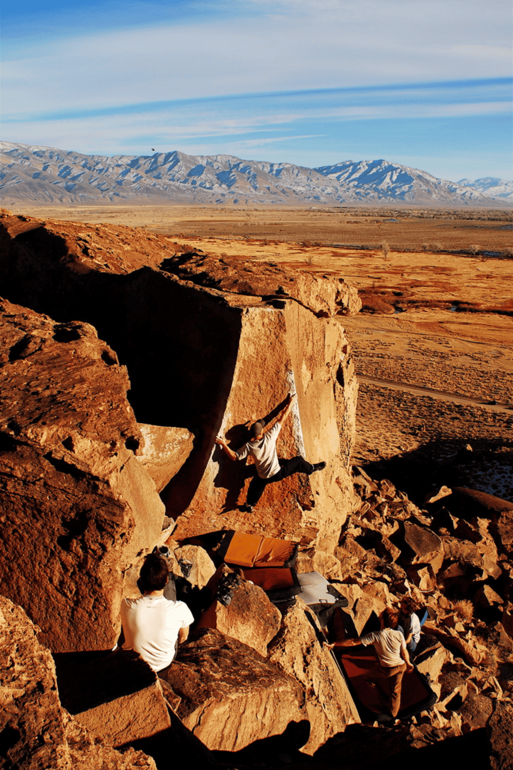 Climbing boulders in desert landscape for outdoor adventure and fitness.