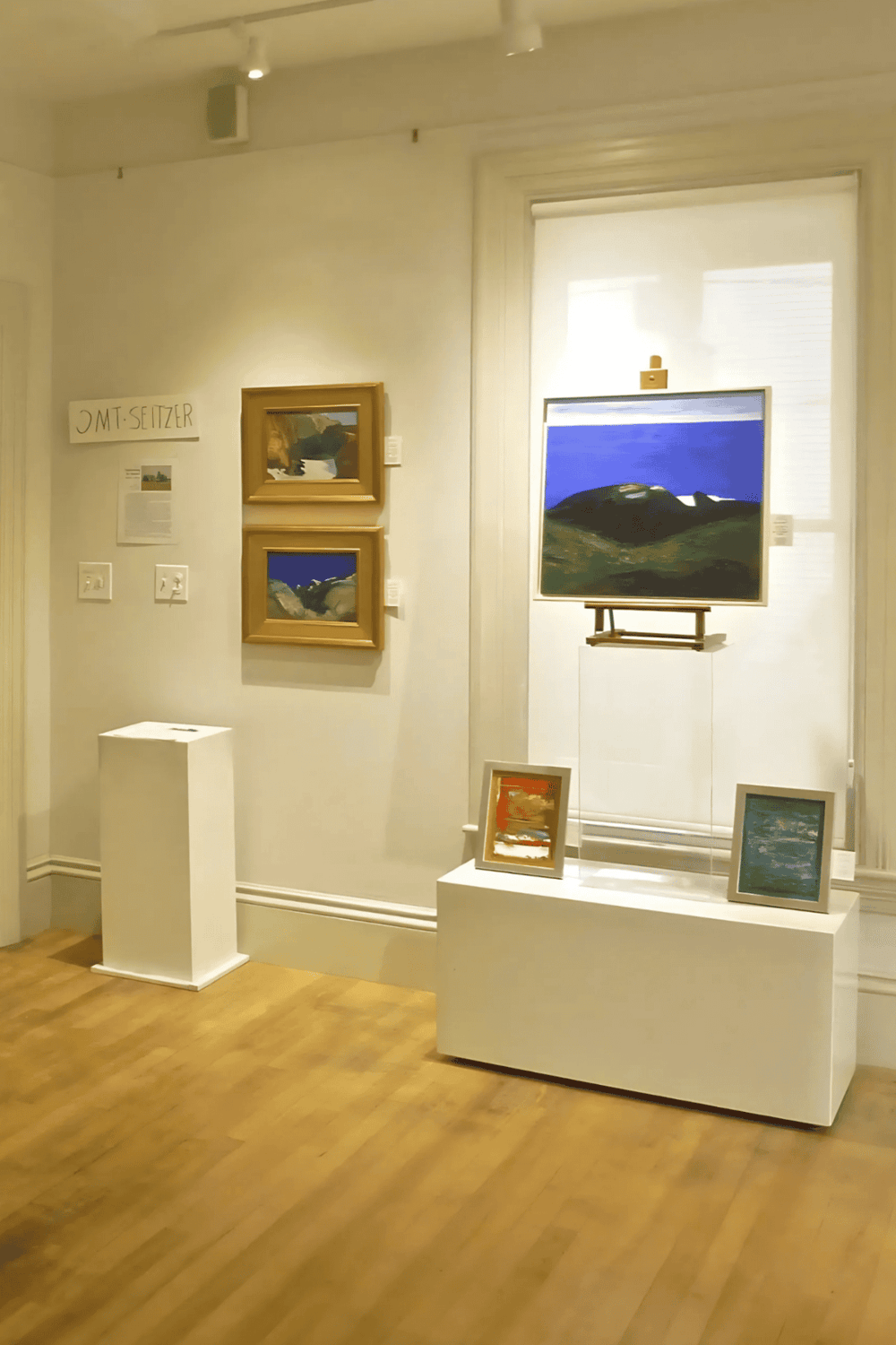 Colorful landscape paintings displayed at QuestForDirections art gallery.
