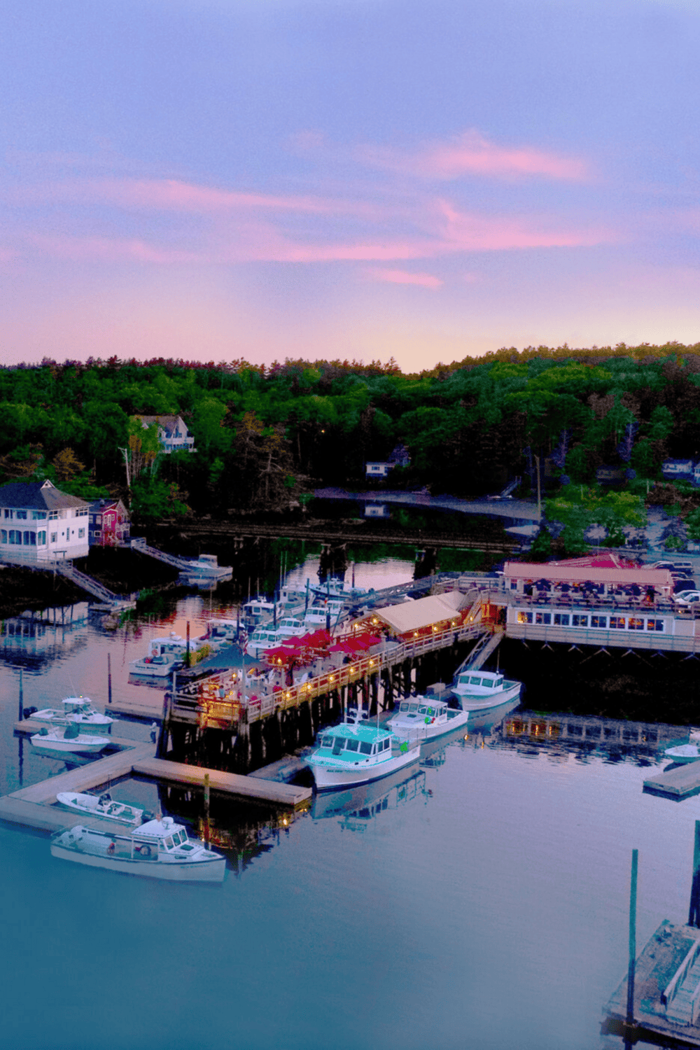 Charming marina dock at dusk, scenic harbor with boats and waterfront dining, perfect for travel and vacation planning.