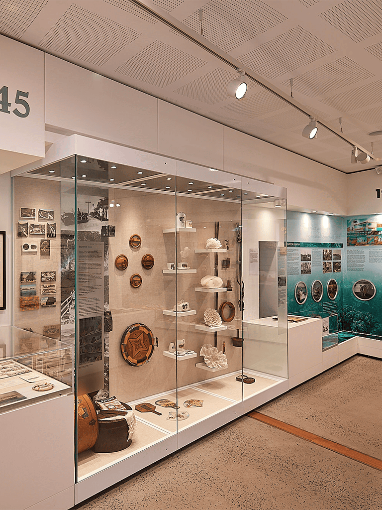 Vintage coastal souvenirs and artifacts display at a maritime museum exhibit.