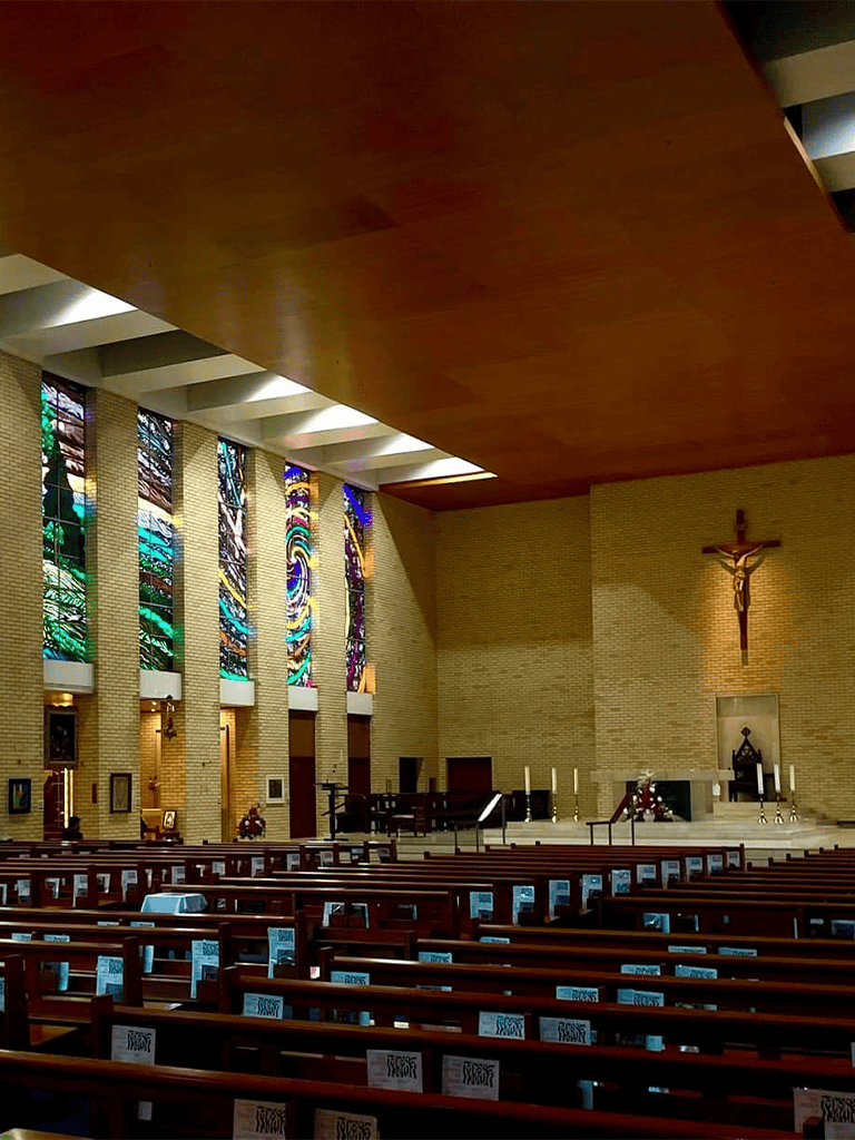 Colorful stained glass windows inside a church or chapel.