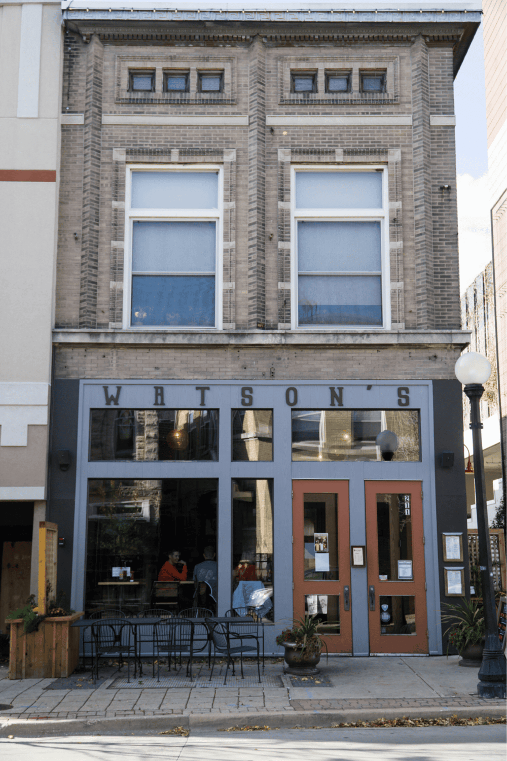 Charming neighborhood restaurant showcases a cozy facade with outdoor seating and inviting interior.