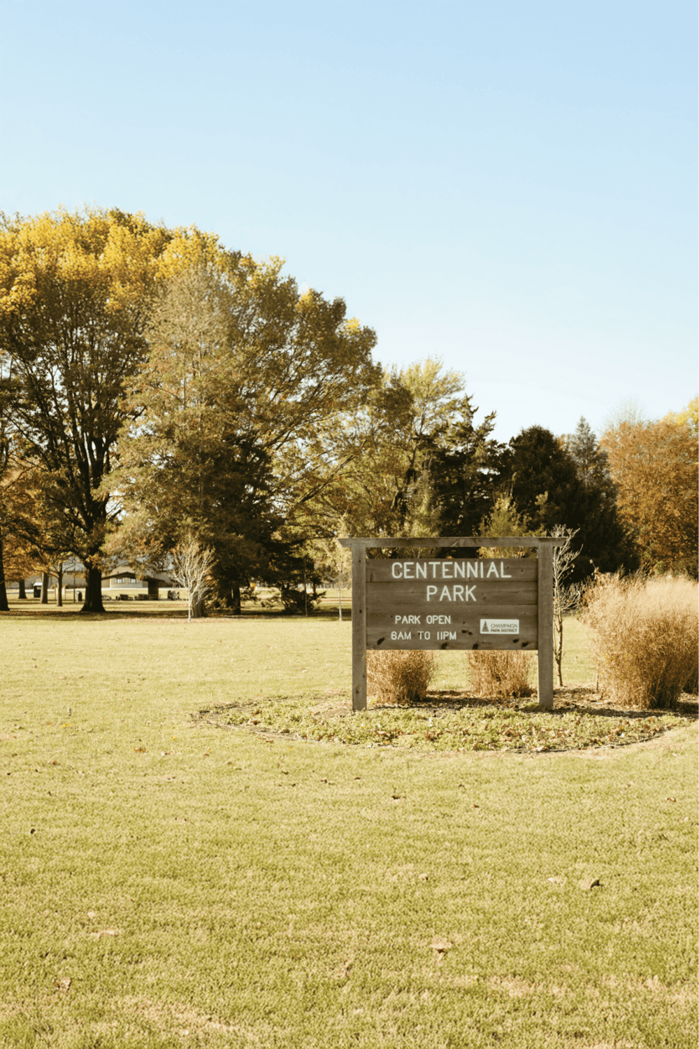 Scenic park entrance sign at Centennial Park during fall season, outdoor recreation, nature, community park, green space.