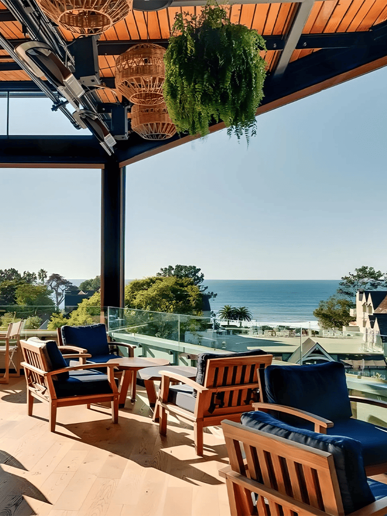 Modern coastal terrace with ocean view, cozy seating, and lush greenery at QuestForDirections.