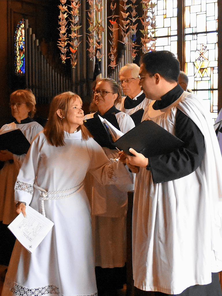 Hopeful woman in white robe talking with choir member in church, spiritual guidance, religious service, faith community, prayer, divine connection.