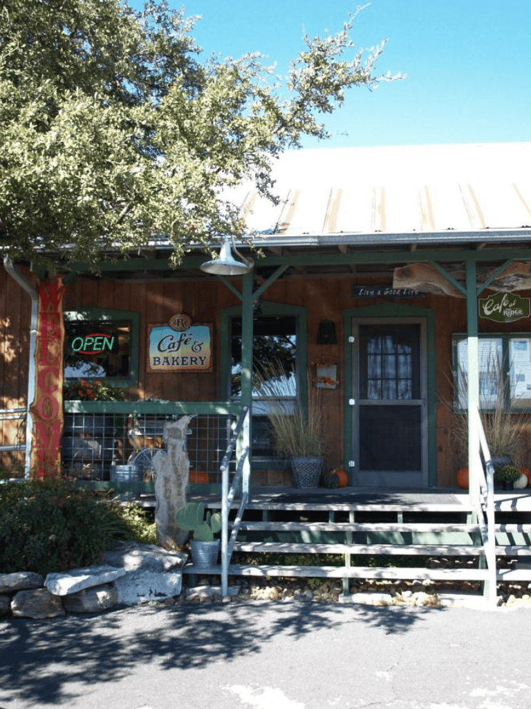 Cozy café and bakery storefront with outdoor decor and welcoming entrance, ideal for breakfast and coffee.
