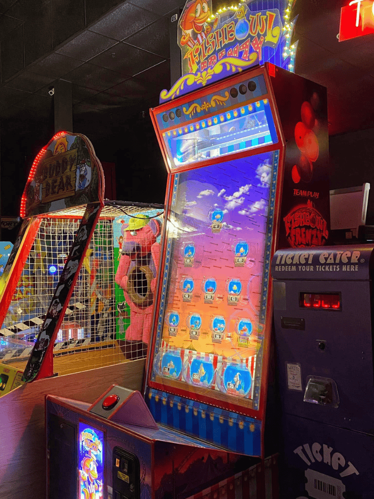 Colorful arcade fish shooting game machine at QuestForDirections entertainment center.