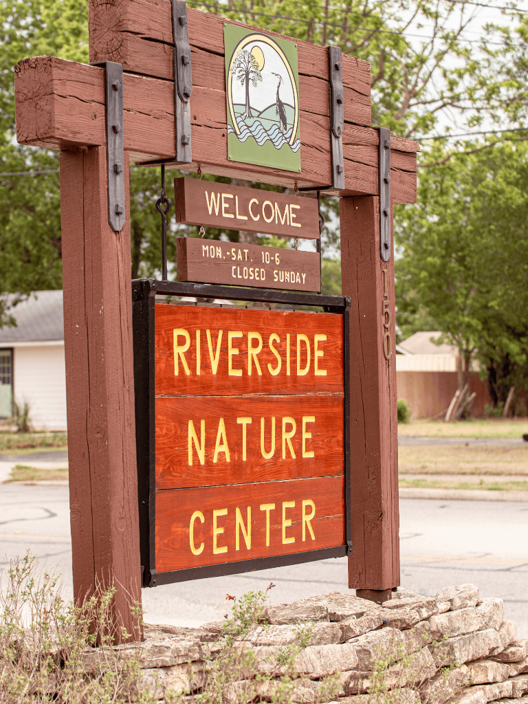 Welcoming Riverside Nature Center sign, open Mon-Sat 10-6, closed Sundays, located at QuestForDirections site.
