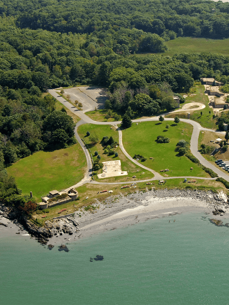 Serene coastal park with lush greenery, walking trails, and beachfront for relaxation and outdoor activities.