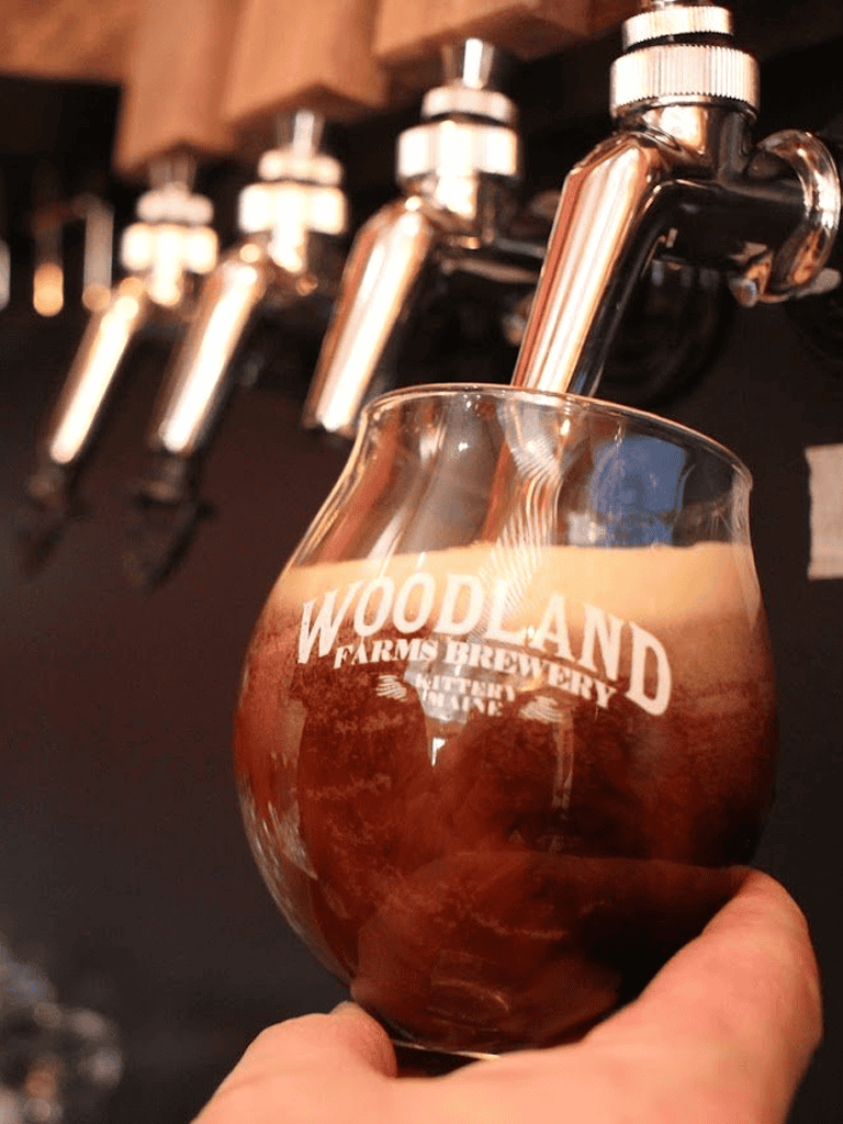 Rich chocolate stout poured from tap at Woodland Farm Brewery.