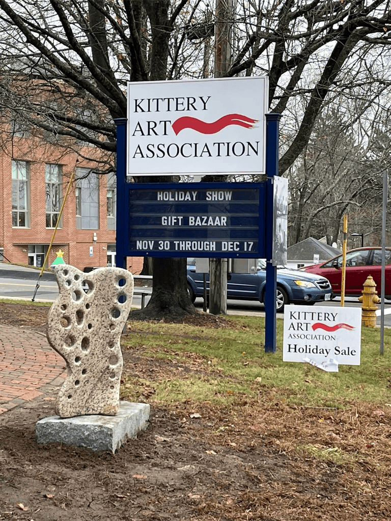 Colorful sign for Kittery Art Association advertising holiday show and gift bazaar with date details.