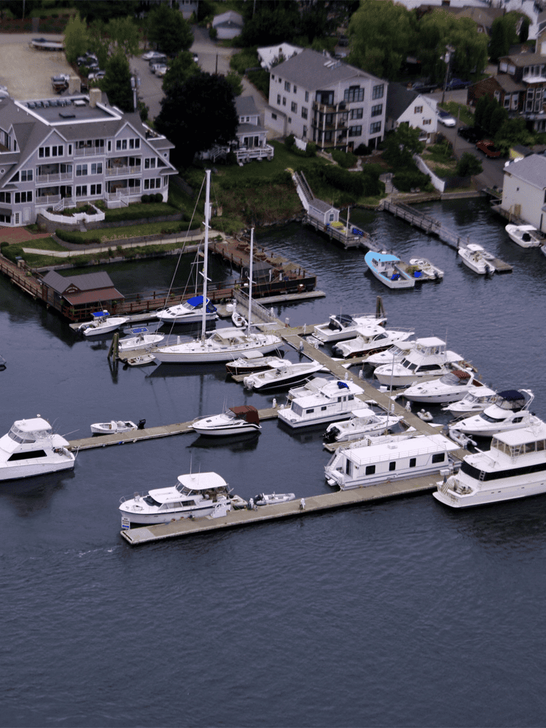 Boats docked at marina in residential waterfront community.