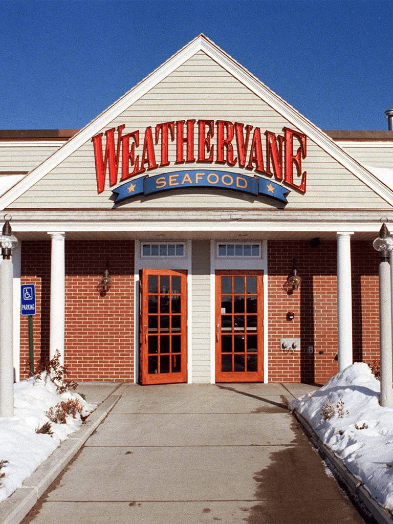 Seafood restaurant WeatherVane sign, exterior view in snowy weather, popular coastal dining spot.
