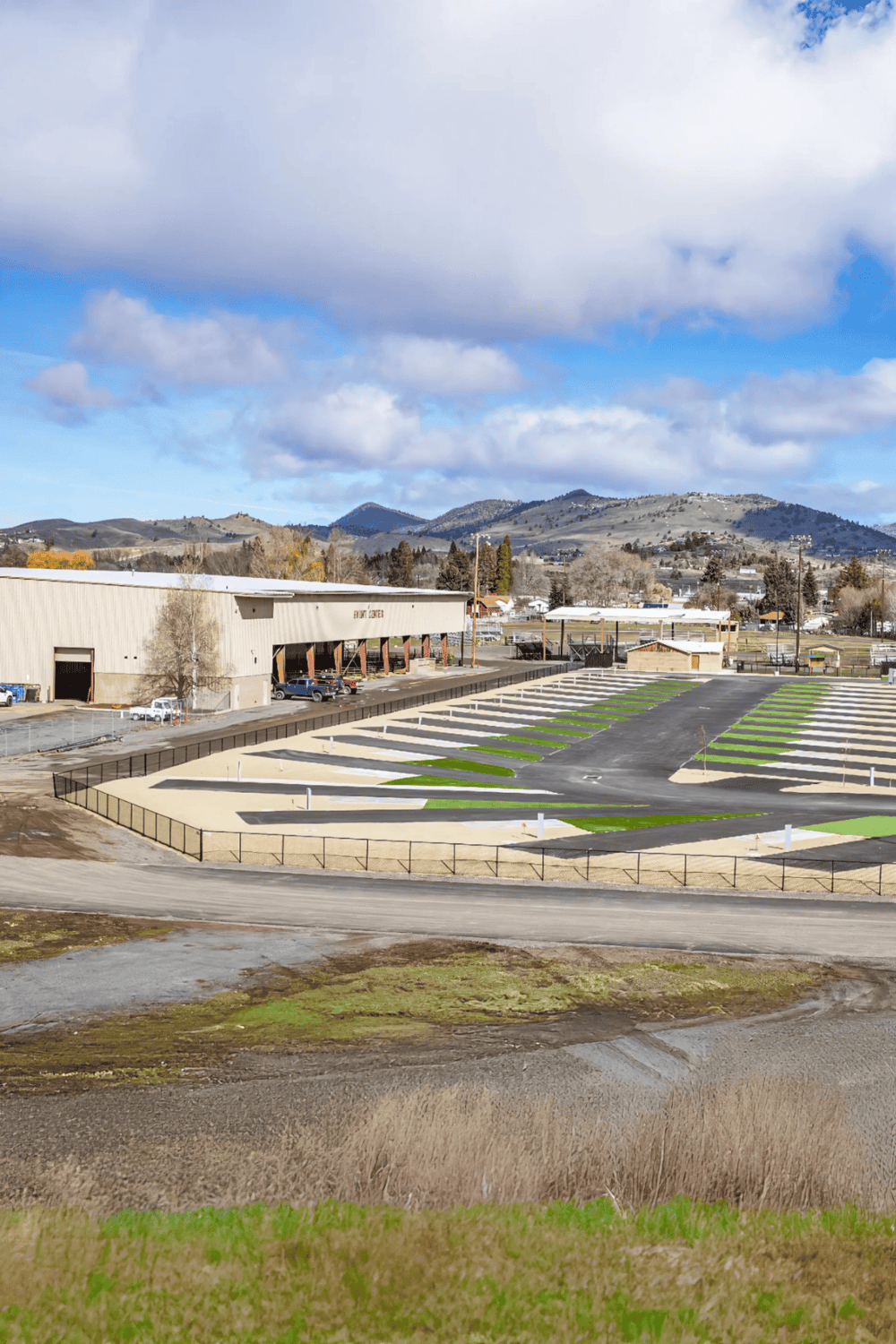 Newly constructed parking lot with green accents and mountain views at QuestForDirections.