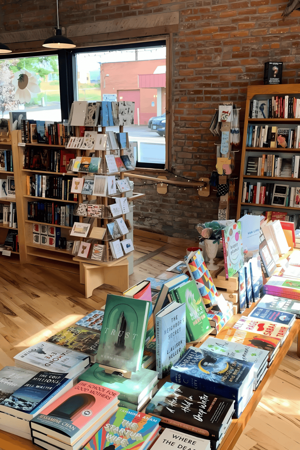 Bookshelf with popular novels and travel guides at QuestForDirections bookstore.