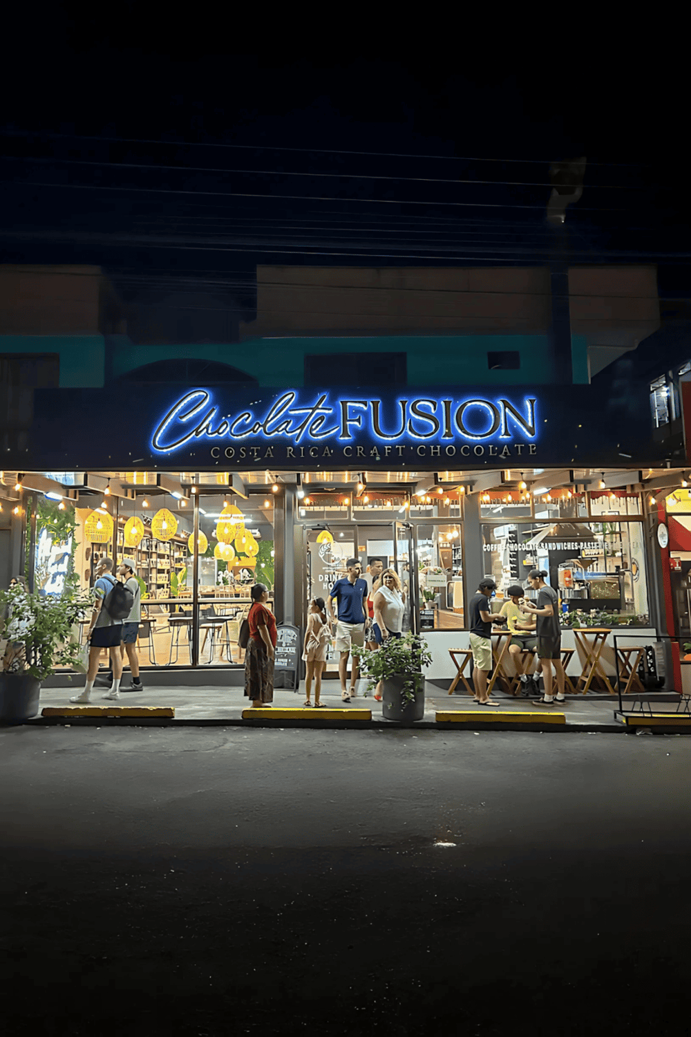 Neon sign for Chocolate Fusion Costa Rica craft chocolate restaurant at night.