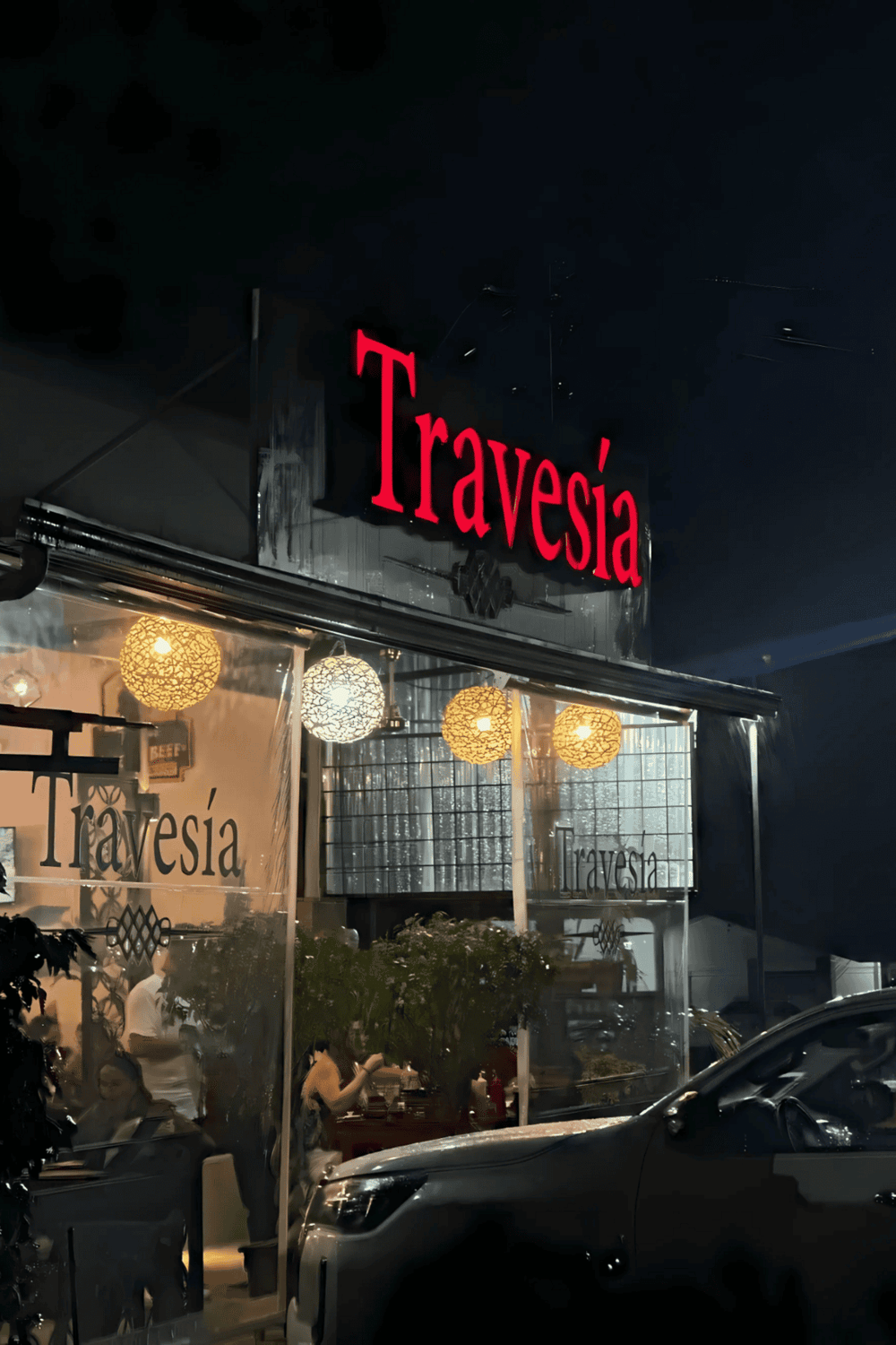 Elegant Travesia restaurant facade with cozy lighting and modern decor, perfect for a dining experience.
