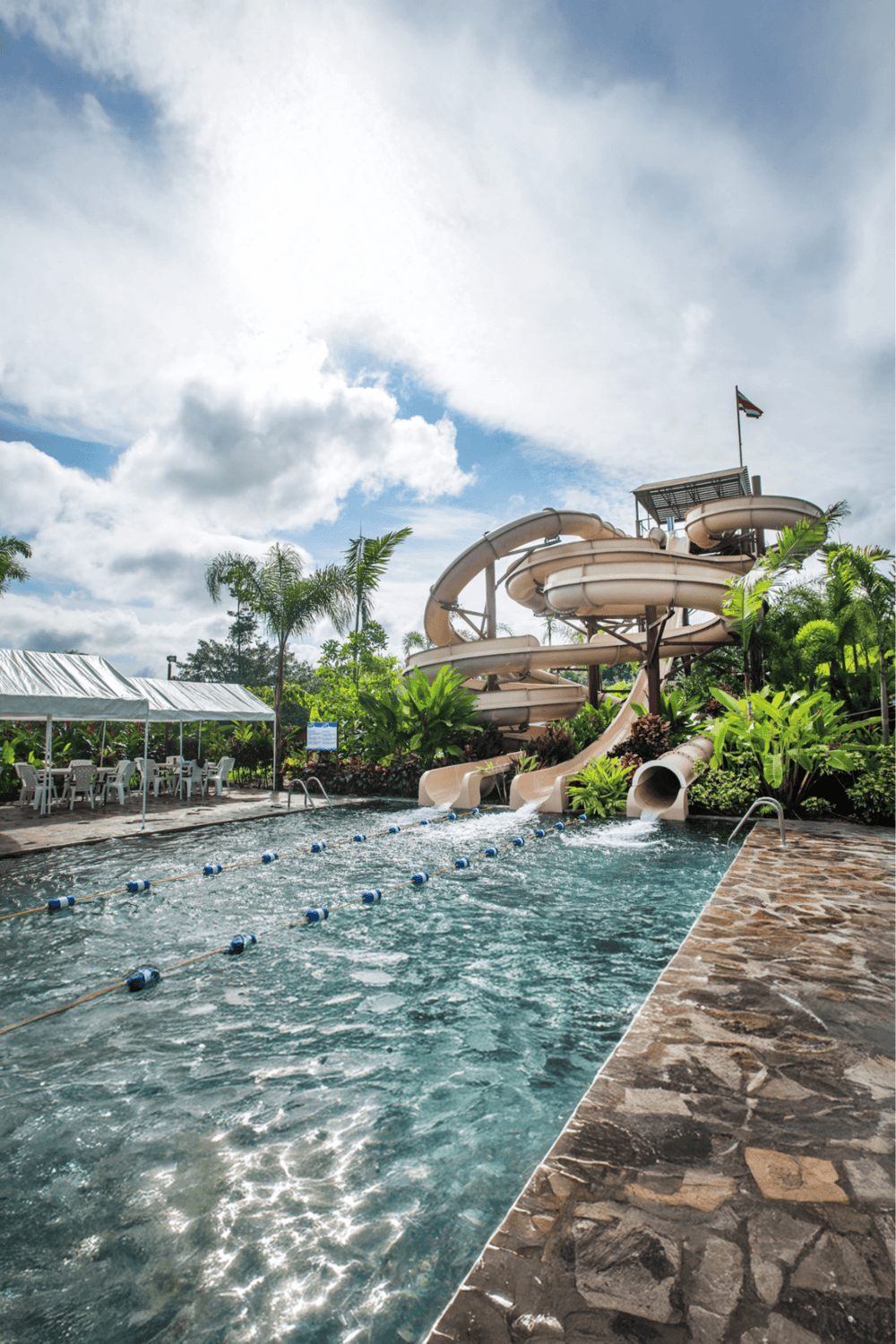 Water park with water slides and lazy river at Quest for Directions resort, family-friendly outdoor recreation.