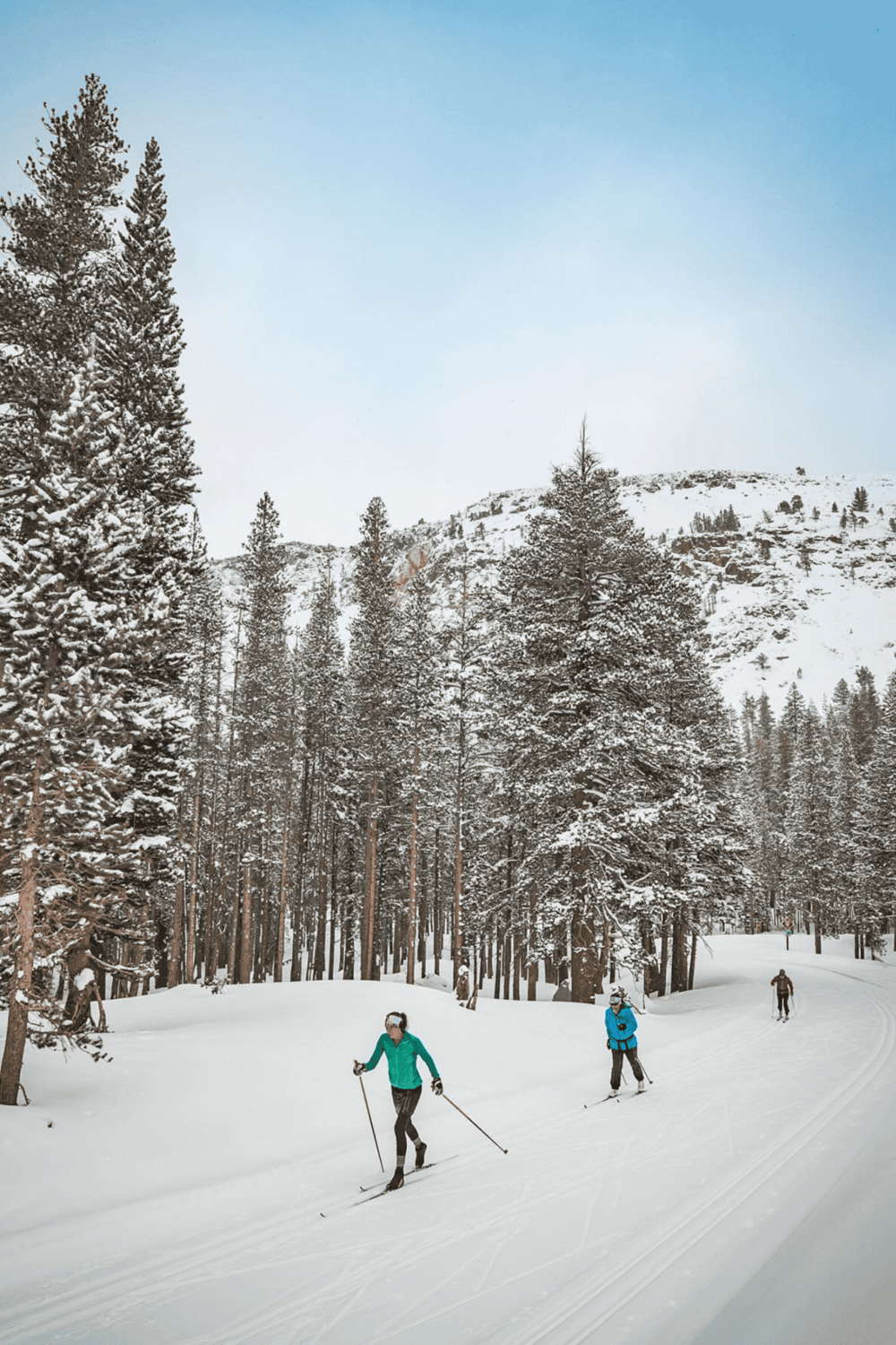 Snowy mountain landscape with cross-country skiers, winter outdoor recreation, scenic mountain trail, QuestForDirections.