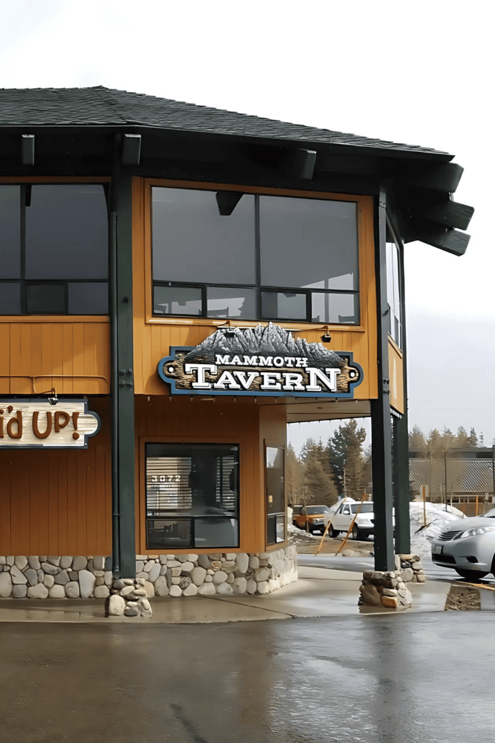 Mammoth Tavern restaurant exterior with mountain-themed decor and parking area, perfect for local dining in Mammoth.