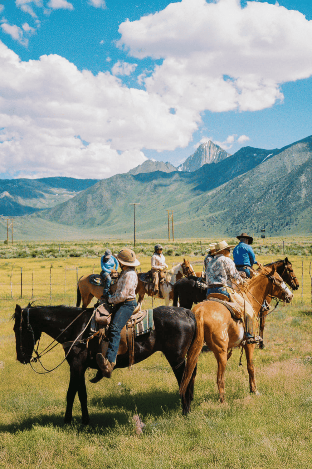Riders on horseback enjoying scenic mountain view in Wyoming, perfect for outdoor adventure and guided horseback tours.