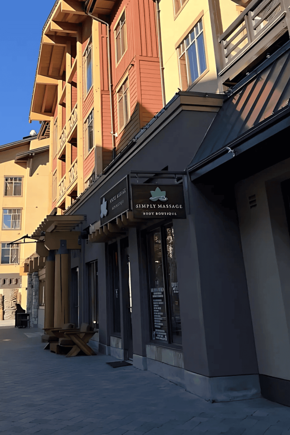 Modern mixed-use building with massage therapy and retail shops in downtown.