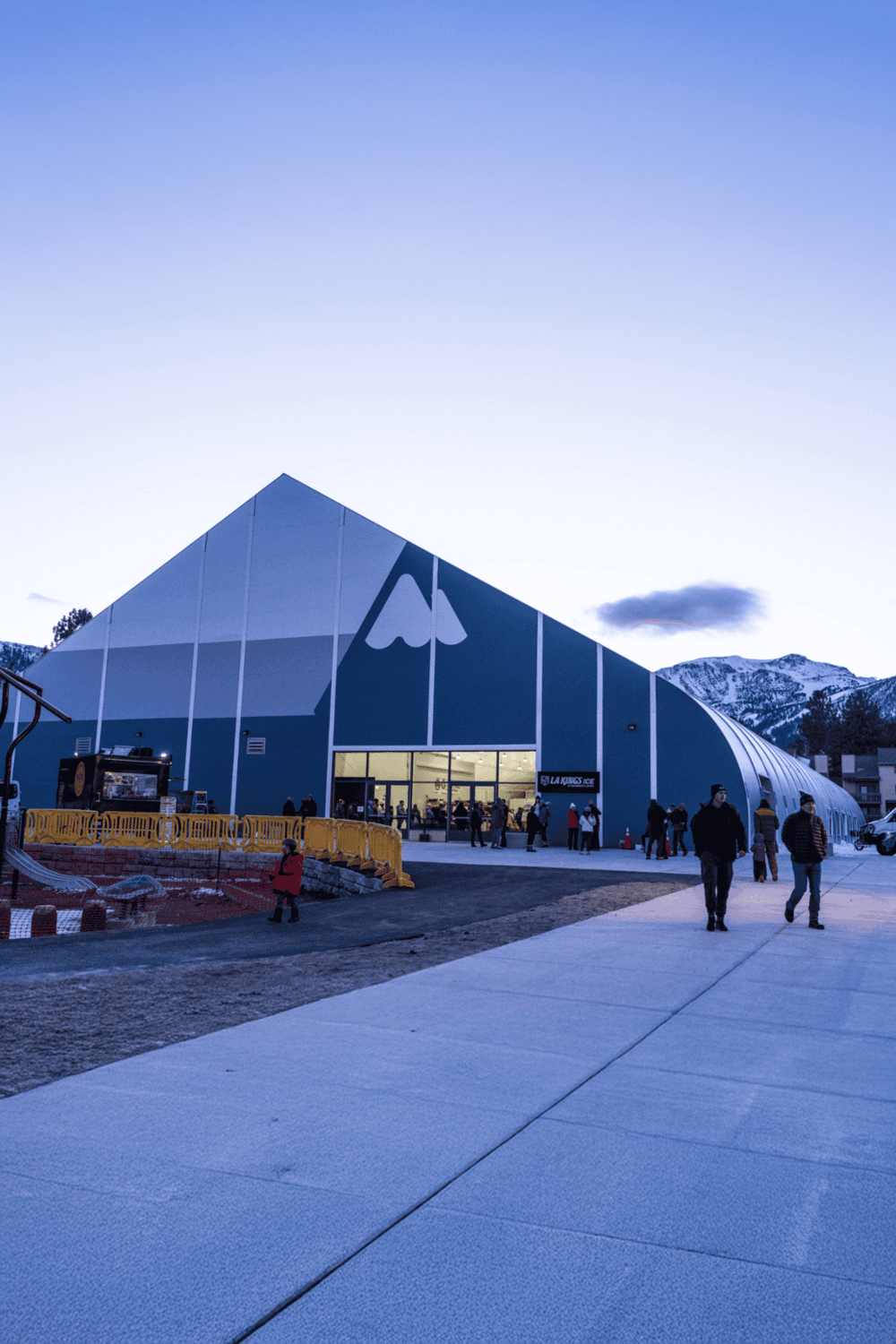 Modern ice skating rink in Mountain Resort, people enjoying winter sports.