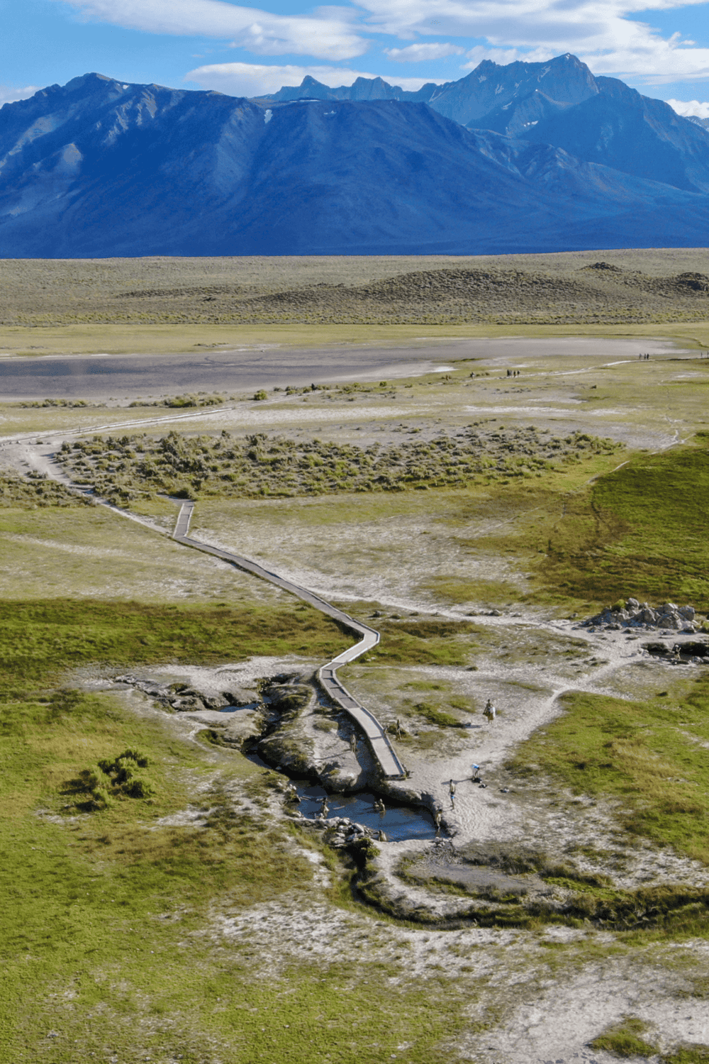 Serene mountain landscape with walking trails and geothermal pools, perfect for outdoor adventures and nature exploration.