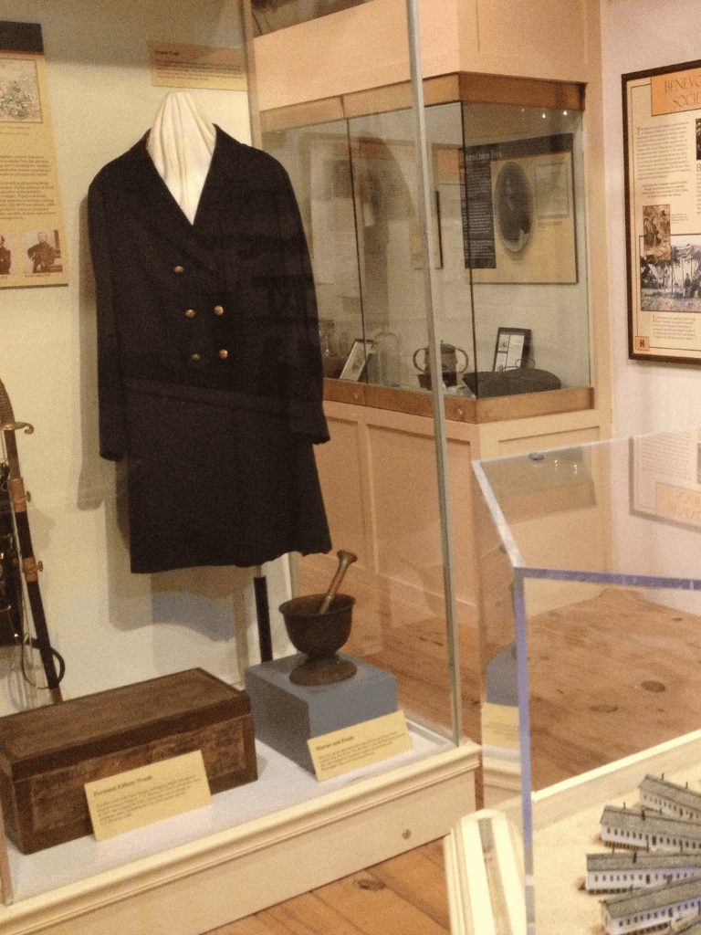 Uniform of a historical female officer or nurse in a museum display, representing early 20th-century medical or military history.