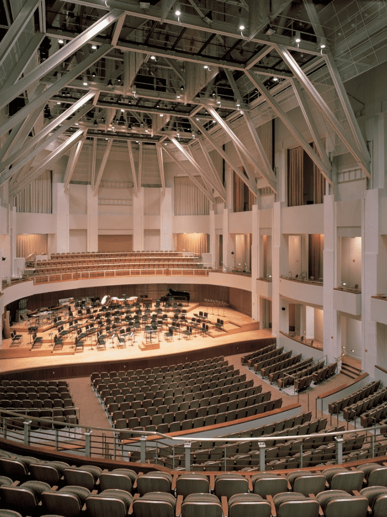 Elegant concert hall with a grand stage and seating for large audiences, ideal for performances and events.
