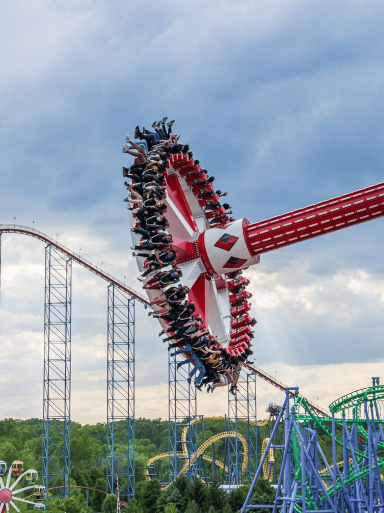Thrilling amusement park ride with passengers on a spinning circular ride ride at an amusement park.