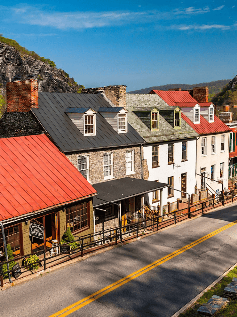 Charming historic buildings along a scenic mountain town street with colorful rooftops and storefronts.