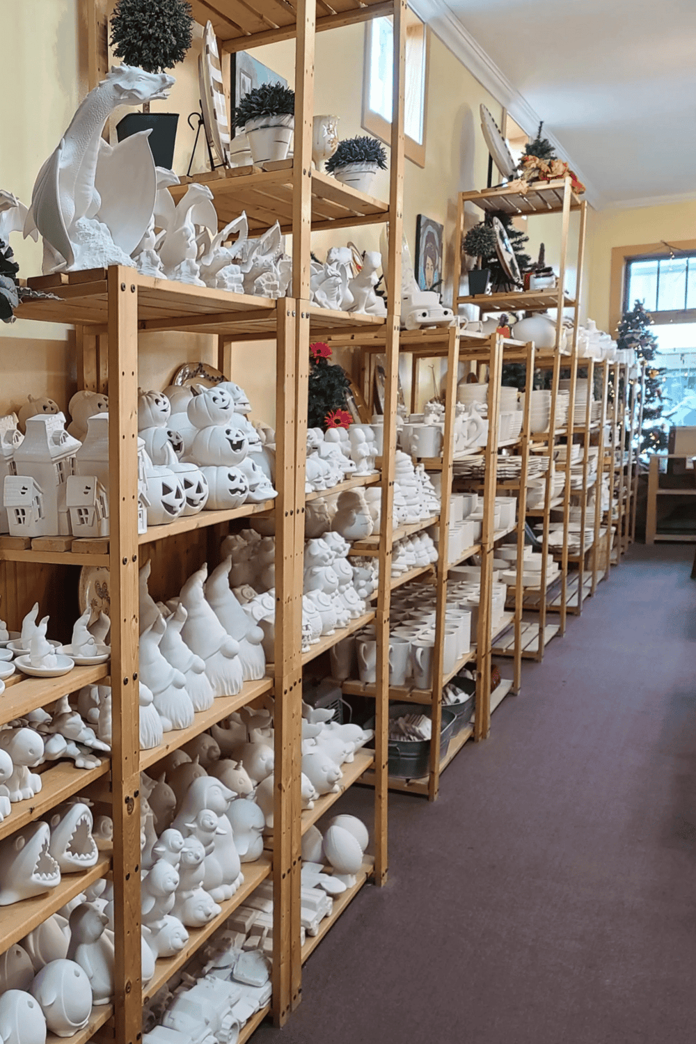 White ceramic Halloween and holiday figurines display shelves at QuestForDirections Halloween decor store.