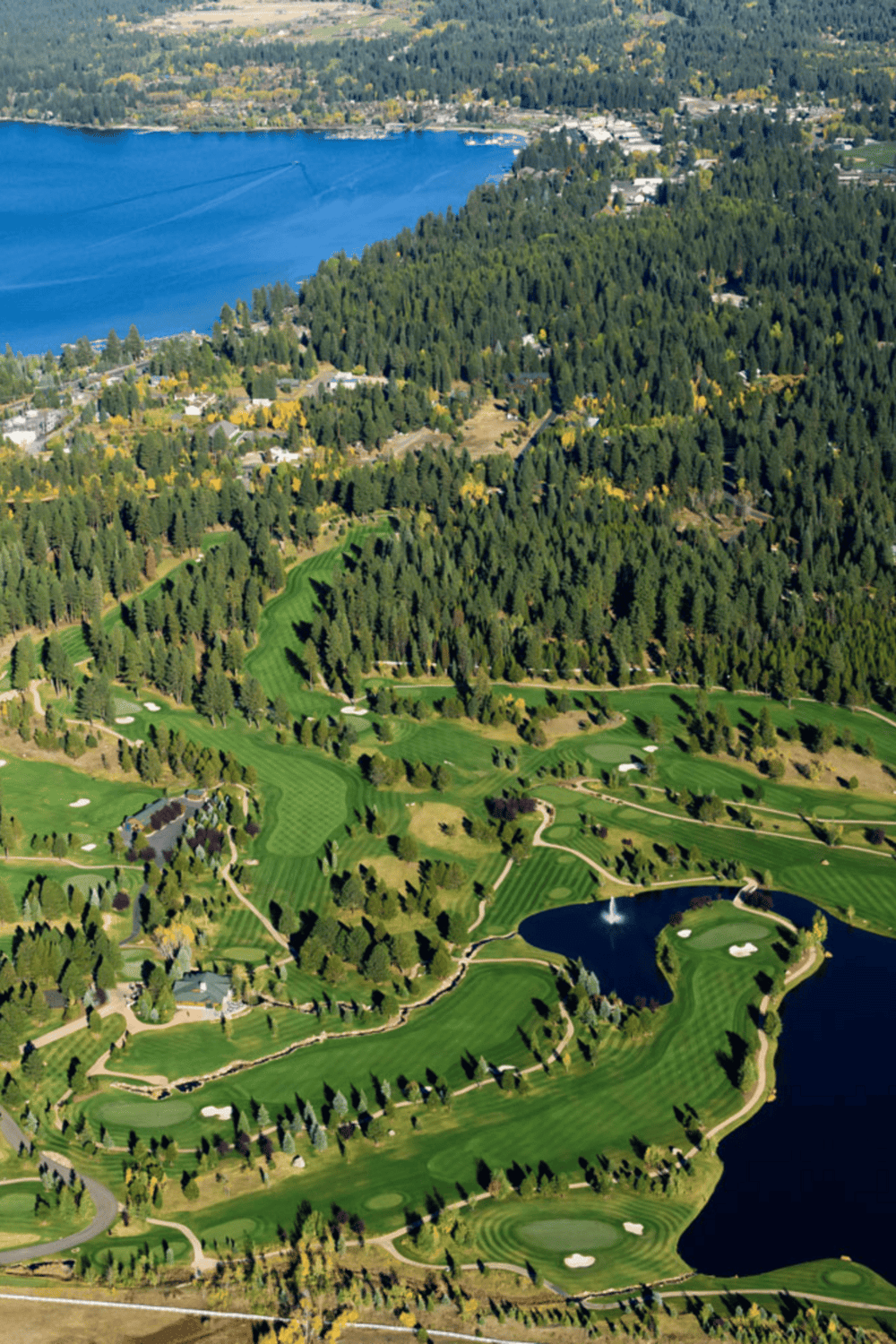 1. Aerial view of lush golf course near a lake with trees and scenic landscape.