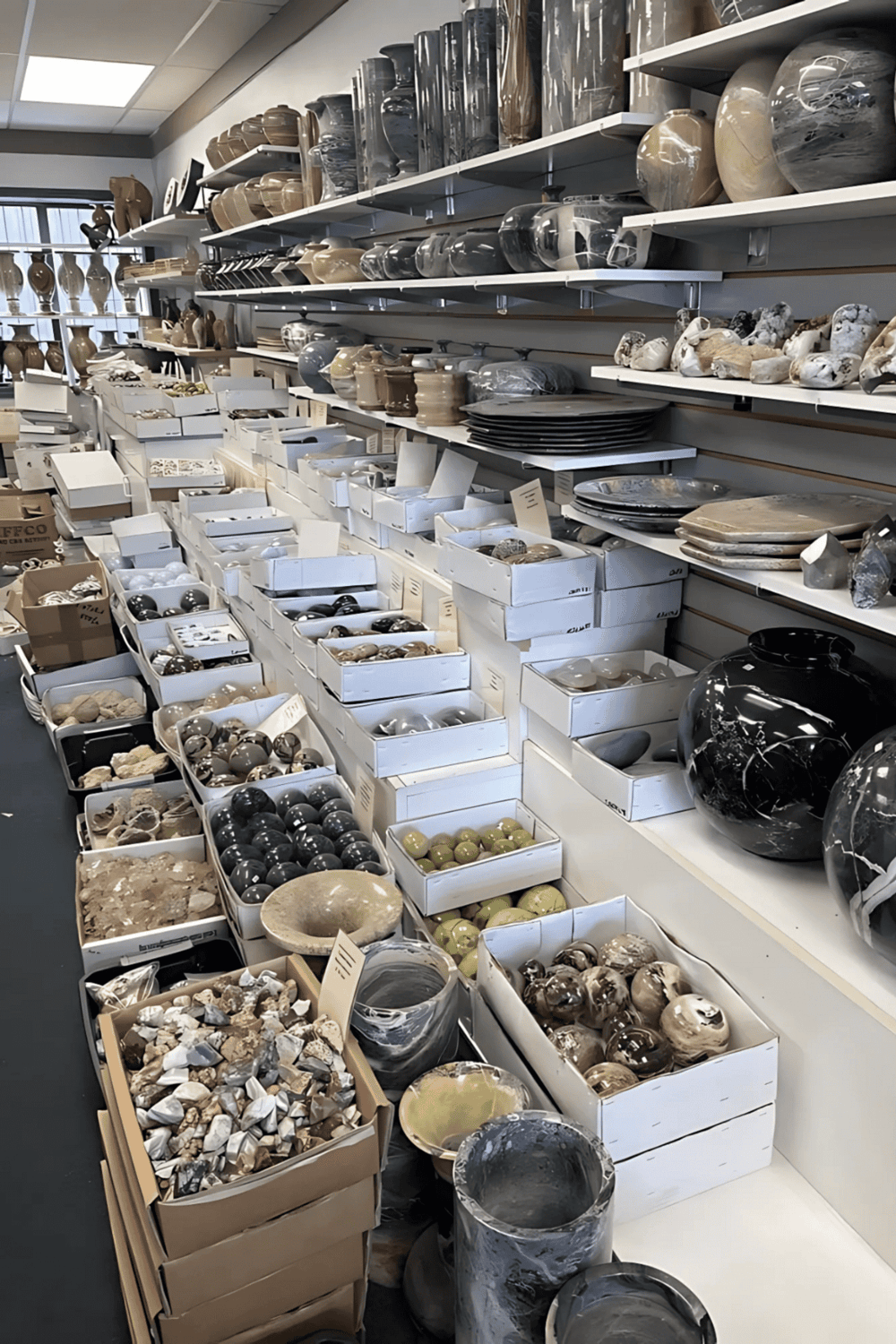 Vases, bowls, and sculptures displayed on store shelves for home decor and interior design.