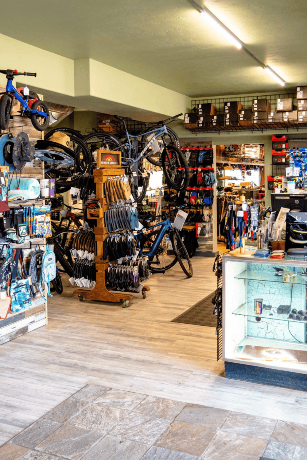Brightly lit outdoor adventure gear and bike shop interior with bicycles and accessories for fun excursions.