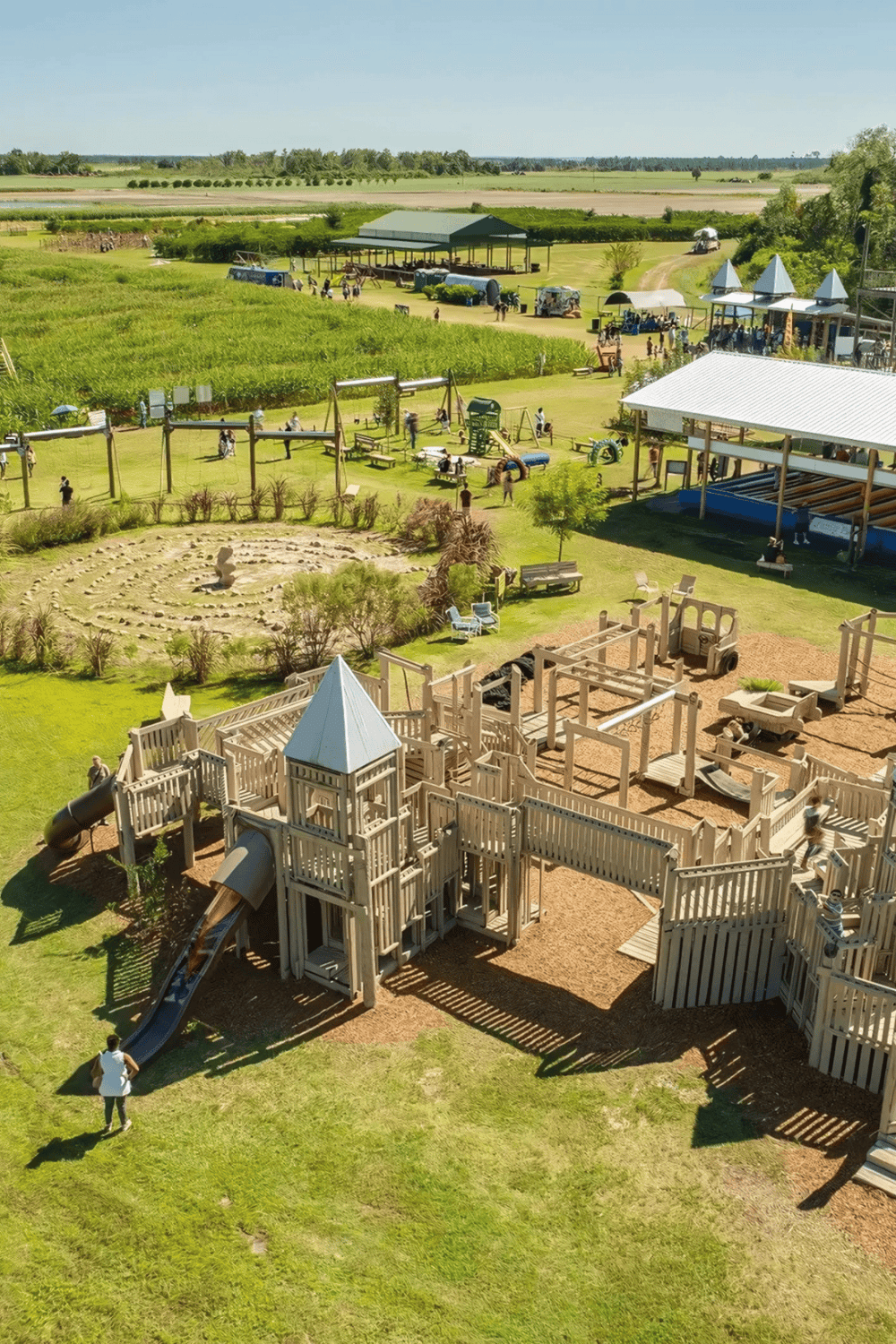 Vibrant outdoor playground and family farm attraction with green fields and picnic areas.