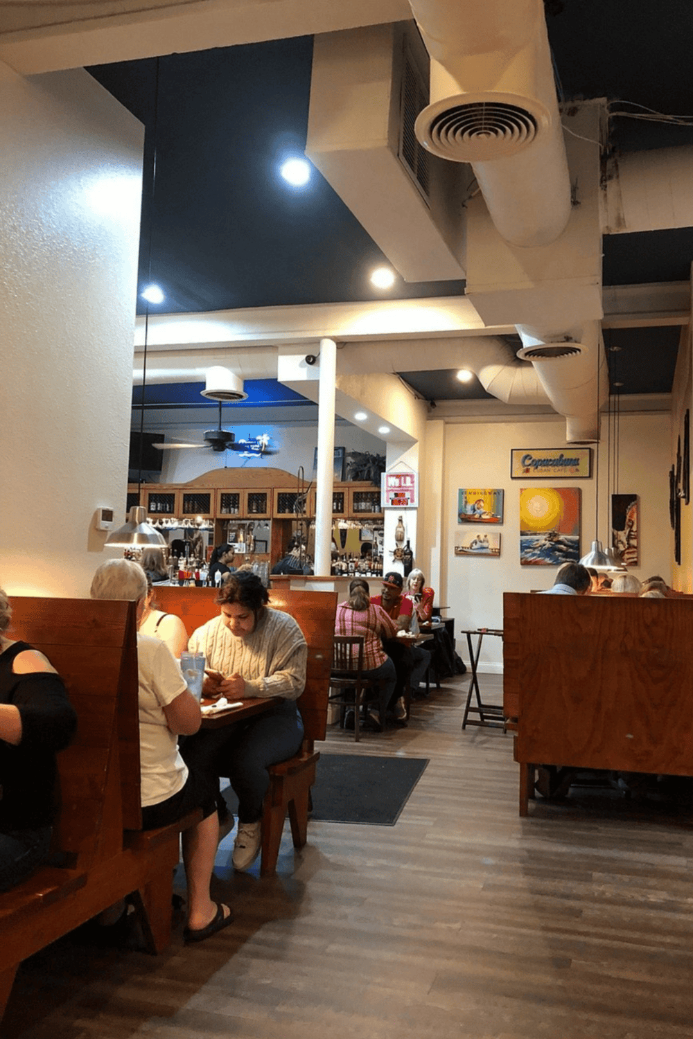 Modern cozy restaurant interior with diverse diners and stylish decor, perfect for exploring dining options with QuestForDirections.