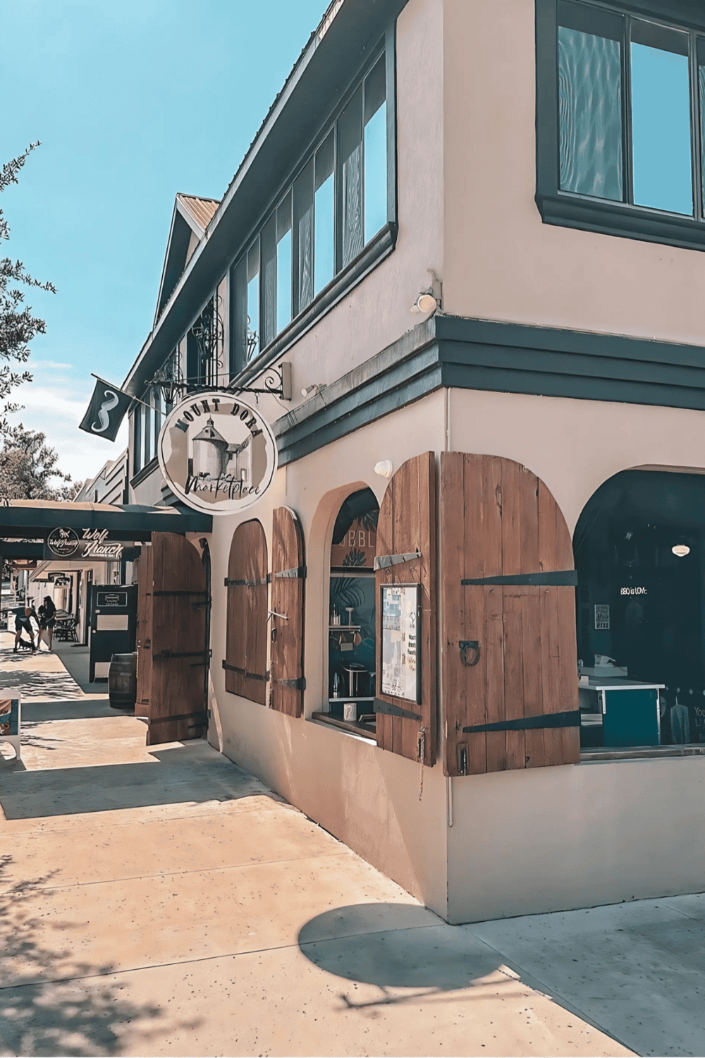 Modern café with rustic wooden shutters and outdoor dining area at QuestForDirections.