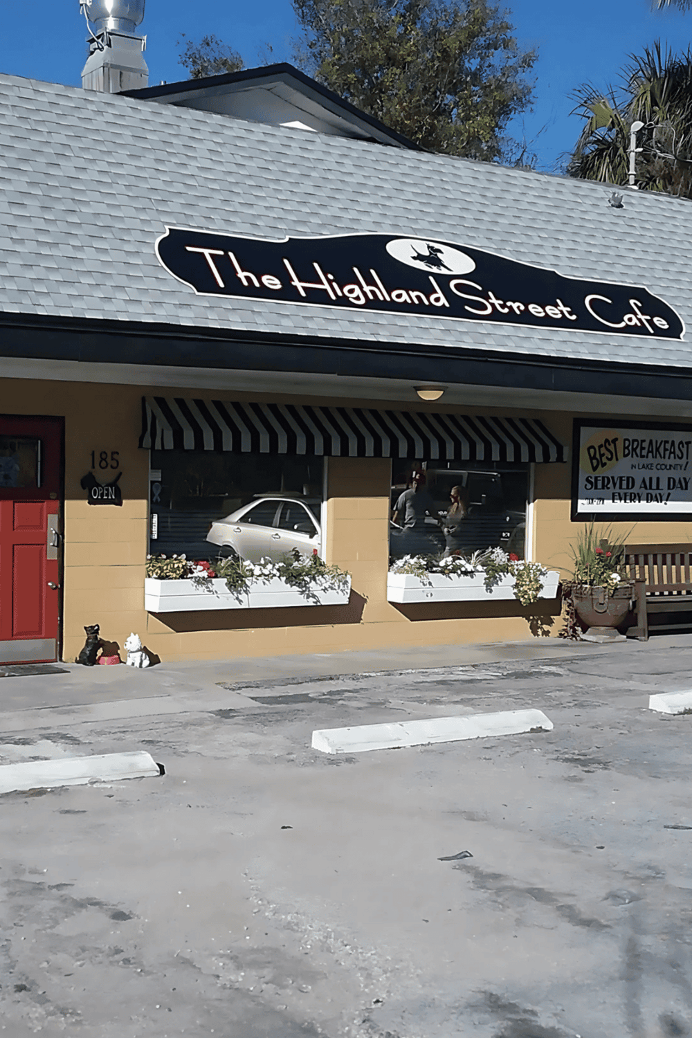 Comfortable cafe exterior with Highland Street sign, inviting atmosphere for local dining and coffee.