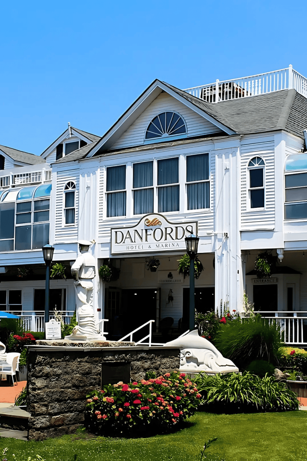 Charming Danfords Hotel & Marina on the waterfront with attractive outdoor decor and lush landscaping.